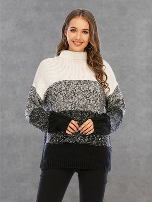Colorblock knit turtleneck sweater with defined panels in white, gray, and black acrylic.