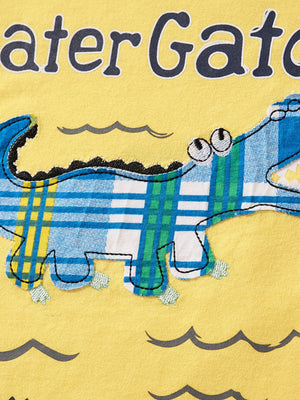 Later Gator toddler graphic tee in yellow with a blue and green plaid alligator applique and wavy water details.