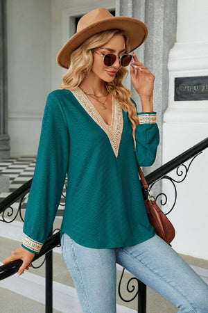 Deep Teal V-neck blouse with textured fabric and lace trim cuffs and neckline.
