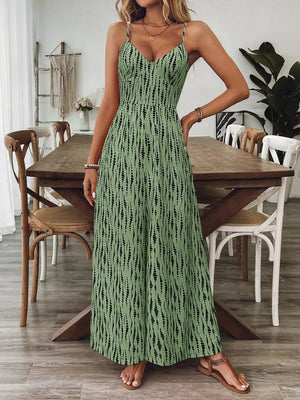 Matcha green wide-leg jumpsuit with black vertical dash print, V-neck, spaghetti straps.