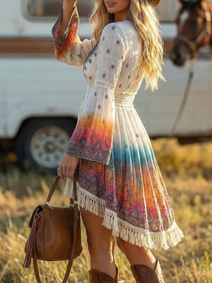 Bohemian fringe hem dress with V-neck, bell sleeves, and a colorful ombre print.