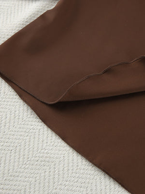 Chocolate ruffled V-neck pajama set with shorts, close-up of fabric detail.