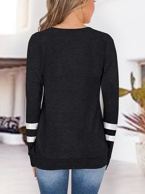 Black raglan v-neck top with varsity stripes on sleeves