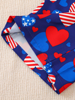 Patriotic baby outfit with heart and stars print on blue cotton fabric.
