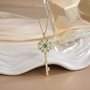 Gold-plated key pendant necklace with green and white stones