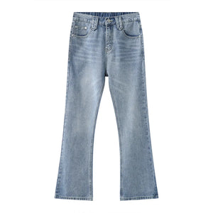 Medium wash wide-leg denim jeans with carpenter pockets and a flared hem.