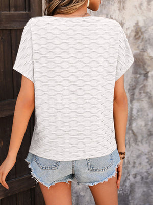 White cap-sleeve blouse with textured wave pattern