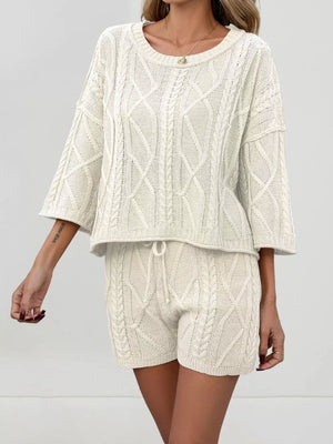 Cream cable-knit two-piece sweater set with crew neck and drawstring shorts.