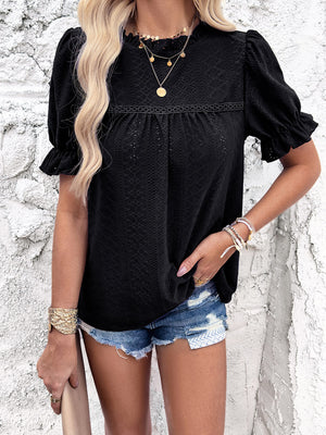 Black eyelet blouse with ruffled puff sleeves and a mock neck