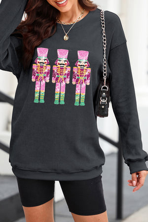 Black ribbed sweatshirt with three sequined nutcracker embellishments.
