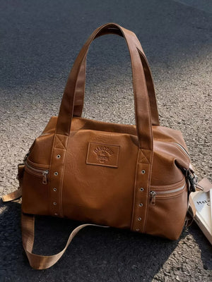 Chic brown pu leather shoulder bag with adjustable strap and zippered pockets.