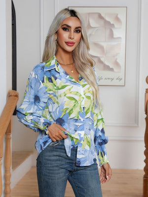 Light blue floral print blouson sleeve button-up shirt with smocked cuffs.