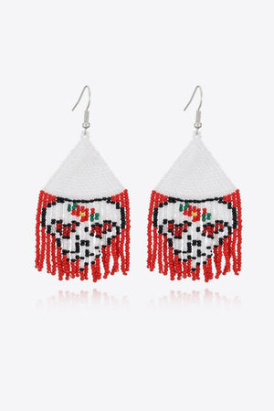 Beaded skull fringe earrings with white, black, red, and green beads.