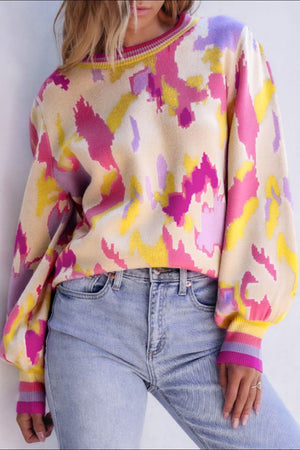 Abstract brushstroke knit sweater with puff sleeves and striped cuffs in floral colors.