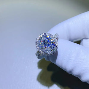 Silver oval halo moissanite engagement ring with pave band