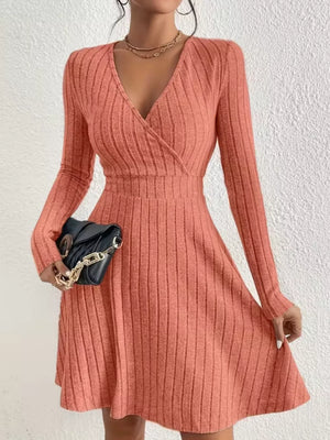 Burnt Coral ribbed wrap mini dress with V-neck and long sleeves.