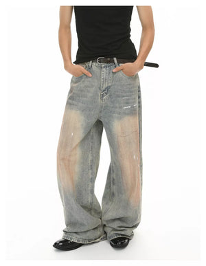 Relaxed fit vintage wash jeans in blue denim with distressed details and baggy legs.