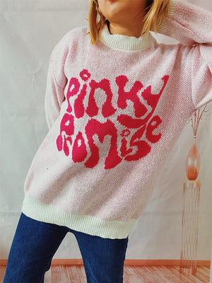 Blush pink knit jumper with a cream neckline and bold pink "Pinky Promise" graphic.