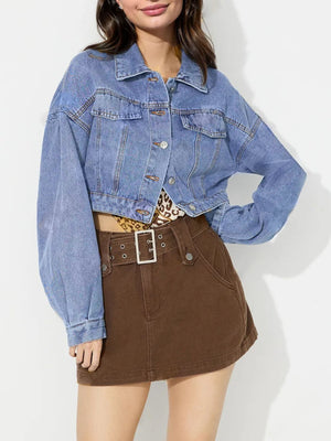 Cropped denim jacket in medium wash with balloon sleeves and buttoned front