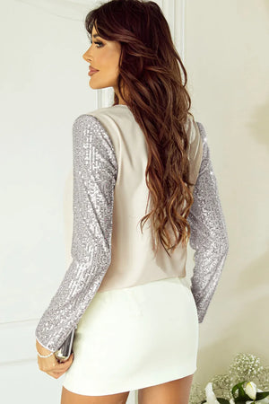 Ivory silk blend blouse with full sequin sleeves.
