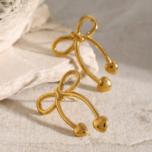 Gold bow drop earrings with heart tips