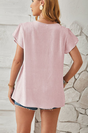 Lilac textured V-neck blouse with flutter sleeves and a relaxed fit.