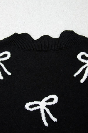 Black knit vest with white bow print and scalloped neckline