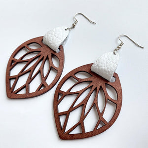 Leaf cutout wood dangle earrings with white leather accent.
