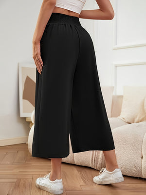 Black smocked waist culotte trousers with a wide leg and cropped length.