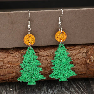 Glittering green acrylic Christmas tree drop earrings with orange circle accents.