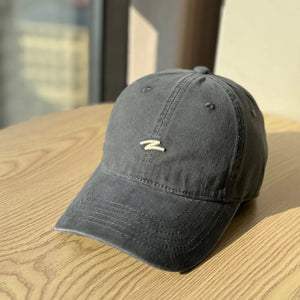 Distressed dark gray cotton baseball hat with curved brim and embroidered detail.