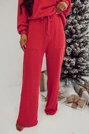 Deep Red ribbed knit lounge pants with drawstring waist and pockets.