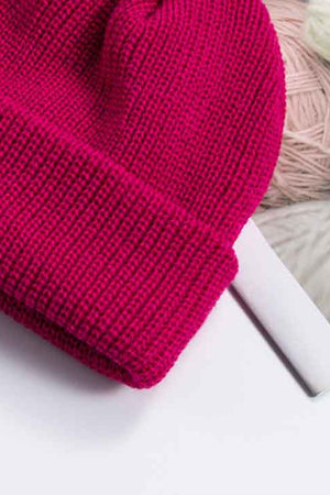 Ribbed knit beanie in magenta with a turn-up cuff.