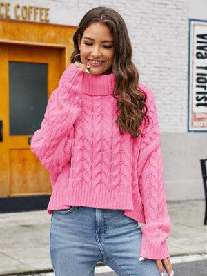 Pink cable-knit acrylic sweater with a choker neckline and ribbed cuffs.