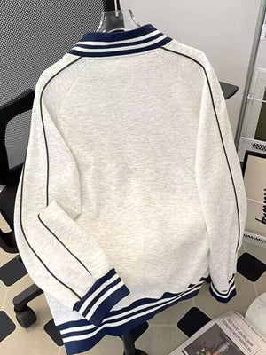 Gray plus-size zip-up sweatshirt with navy blue striped collar and cuffs.