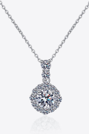 Silver moissanite pendant necklace in sterling silver with a halo of small stones.