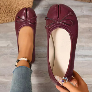Burgundy tabi slip-on flats with bow detail and split toe.