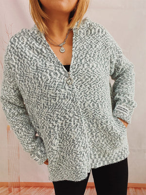Speckled knit relaxed zip-up hoodie in a light grey and white blend, featuring a ring zipper and pockets.