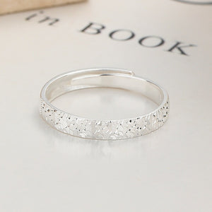 Textured sterling silver adjustable ring with a subtle hammered pattern.