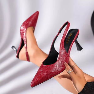 Red embossed leather kitten heel slingback pumps with pointed toe and adjustable ankle strap.