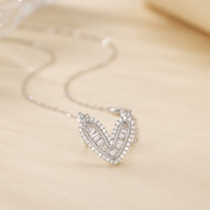 Sterling silver heart pendant necklace with baguette and round crystals on a delicate chain.