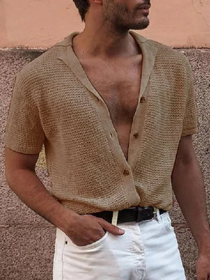 Beige textured knit resort shirt with short sleeves and button front, styled with white pants.
