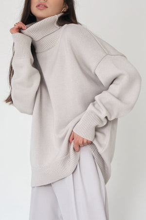 Relaxed roll-neck sweater in light gray knit with a boxy cut and ribbed cuffs and hem.