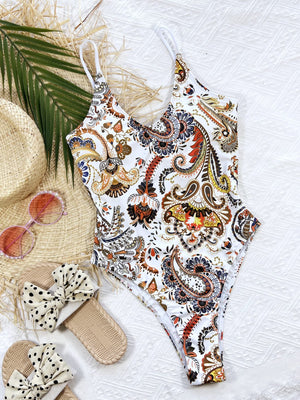 Paisley print tie-back one-piece swimsuit in white with adjustable straps and a V-neck.