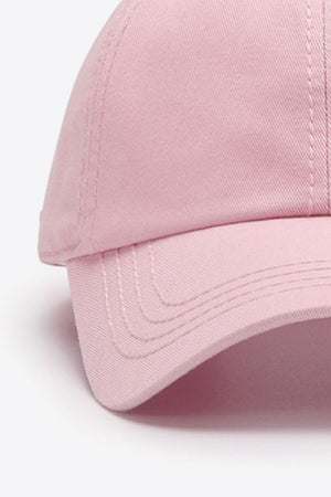 Pink canvas baseball cap with stitched details on the brim and crown.