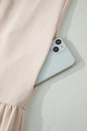 Beige halter maxi dress with lace hem detail and hidden side pocket for a phone.