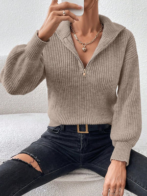 Taupe ribbed zip-up sweater with a high collar and balloon sleeves