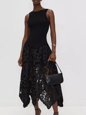 Black crochet midi dress with asymmetrical hem and cutout details, sleeveless ribbed bodice.