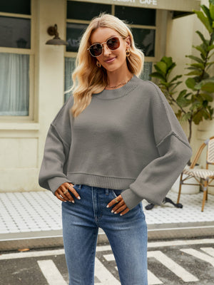 Dropped shoulder knit sweater in heather gray with balloon sleeves and crew neck.