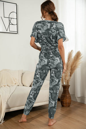 Gray camouflage print jumpsuit with short sleeves and elastic waist.